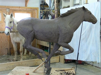 sculpting a clay horse